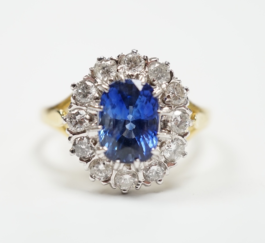 A modern 18ct gold, sapphire and diamond set oval cluster ring, size O, gross weight 5.6 grams.